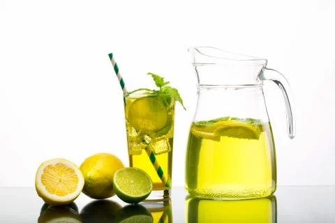 Lemonade pitcher with lemon Stock Photos