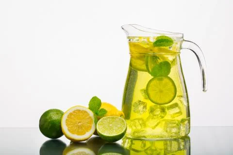 Lemonade pitcher with lemon Stock Photos