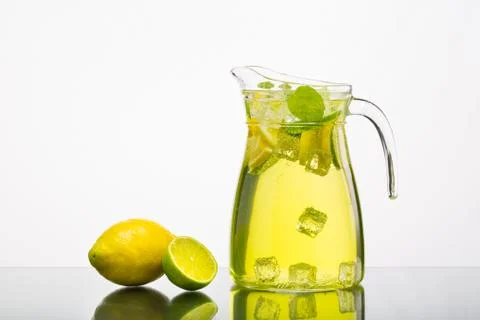 Lemonade pitcher with lemon Stock Photos