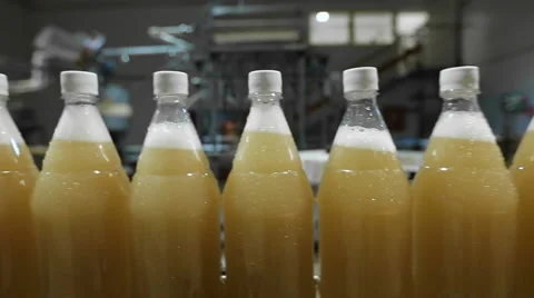 Lemonade in plastic bottles on the conveyor Stock Footage 63861034