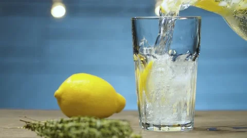 Lemonade pouring into a glass Stock Footage 142882816
