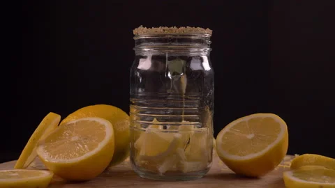 Lemonade Pouring into Jar with Lemon Stock Footage 130985093