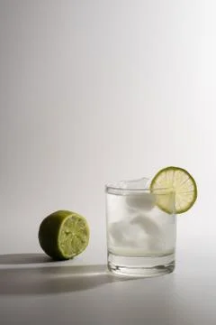 Lemonade with slice lime on white background. Stock Photos