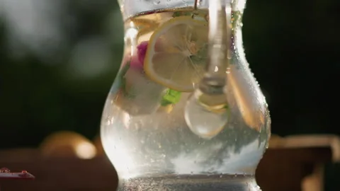 Lemonade sparkling pitcher. Bubbles dance in lemon beverage pitcher Stock Footage 334064023