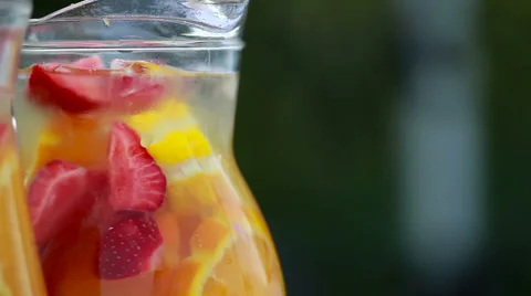 Lemonade with strawberries in the decanter Stock Footage 67749707