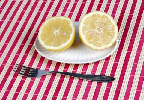 Lemons and fork Stock Photos
