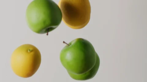 Lemons and green apples falling in milk, abstract food shot Stock Footage 128490757
