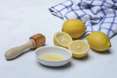 Lemons and lemon squeezer, squeezed lemon and lemon juice Stock Photos