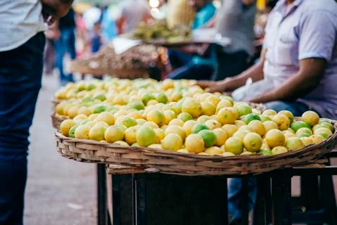 Lemons and lime in a large wicker basket on the market in India Stock Photos