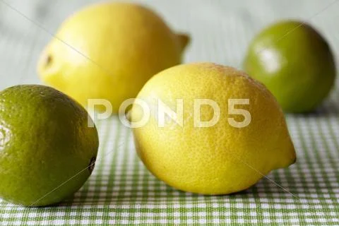 Lemons And Limes On A Green And White Checked Tablecloth