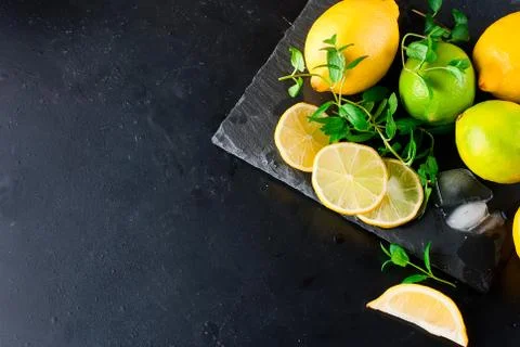 Lemons and limes with mint Stock Photos