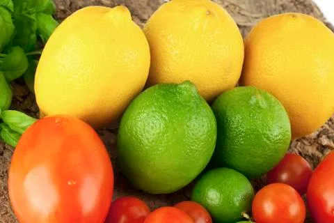 Lemons and tomatoes Stock Photos