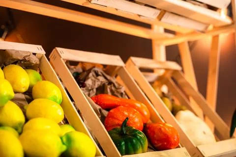 Lemons and vegetables on a shelf in boxes Stock Photos