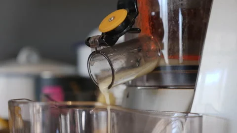 Lemons being squeezed in a juicer side on Stock-Footage 143236014