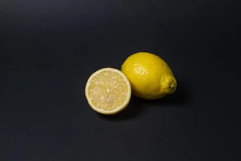 Lemons on a black background. Citrus fruit. Healthy food. Stock Photos