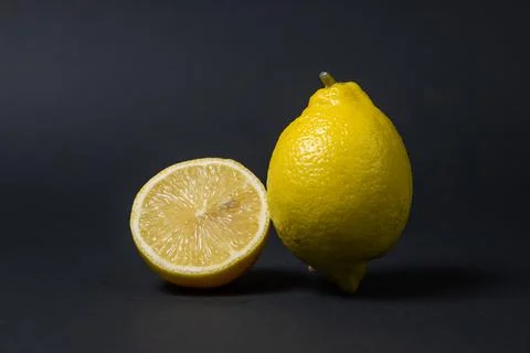 Lemons on a black background. Citrus fruit. Healthy food. Stock Photos