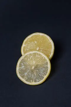 Lemons on a black background. Citrus fruit. Healthy food. Stock Photos