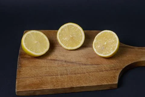Lemons on a black background. Citrus fruit. Healthy food. Stock Photos