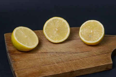 Lemons on a black background. Citrus fruit. Healthy food. Stock Photos