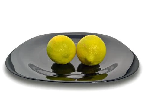 Lemons on a black plate Stock Photos
