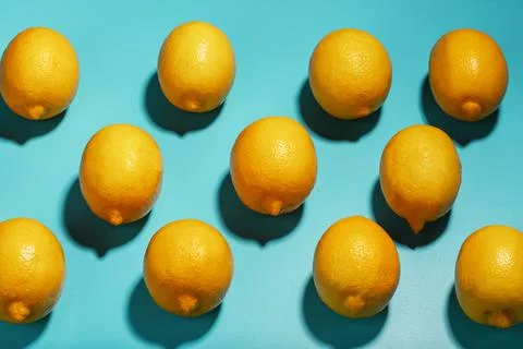 Lemons on a blue background with a pattern in the form of a pattern. Stock Photos