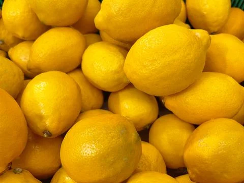 Lemons in close-up. Background of lemon fruit. Vitamin C. Stock Photos