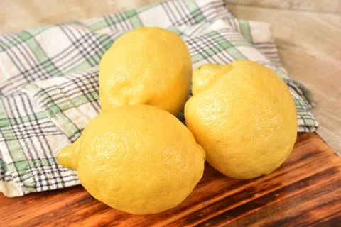 Lemons on a cutting board Stock Photos
