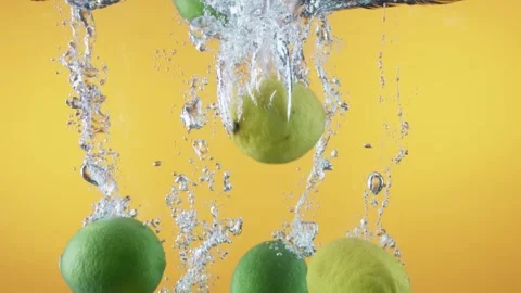 Lemons drop into water slow motion Stock Footage 138850550