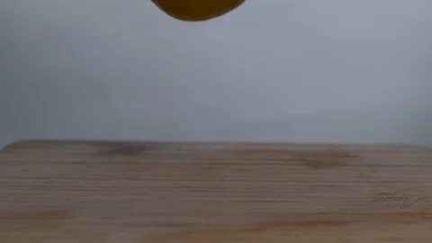 Lemons falling and bouncing in slow motion onto a cutting board Stock Footage 100009050
