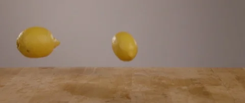 Lemons Falling Onto Cutting Board In Slow Motion 스톡 동영상 105374333