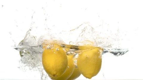 Lemons falling into the water with a big splash Stock Footage 123654831