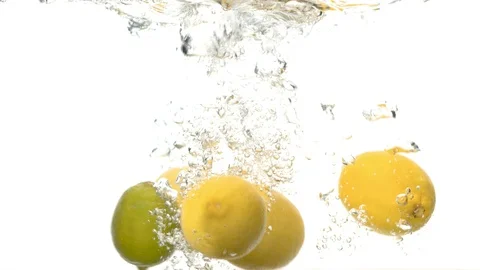 Lemons falling into the water with a big splash Stock Footage 123654872