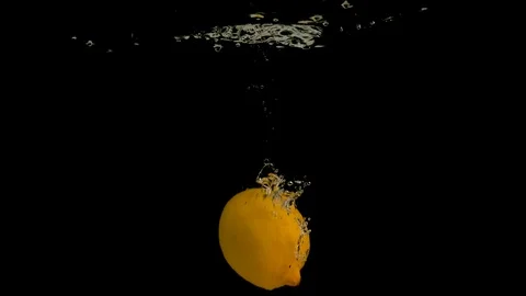 Lemons falling into water on black background. Bright high quality video Stock Footage 117276917
