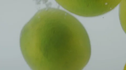 Lemons falling in water Stock Footage 98300088
