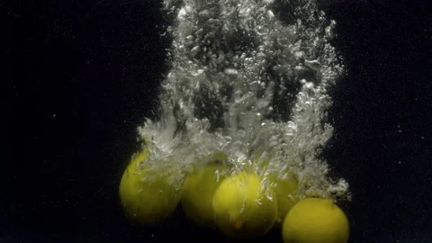 Lemons falling into the water Stock Footage 123704602