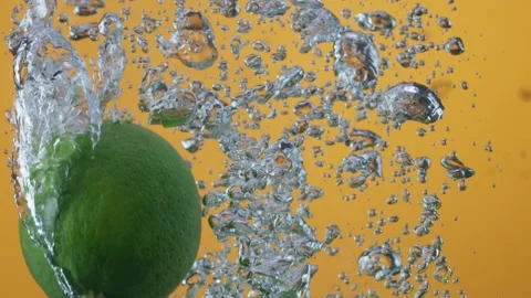 Lemons fell in water macro slow motion Stock Footage
