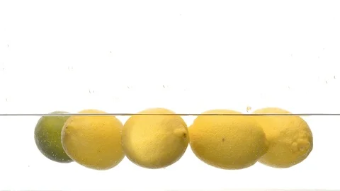 Lemons floating on the water surface Stock Footage 123654845