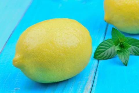 Lemons fruit with mint on table Stock Photos
