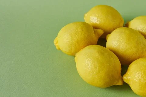 Lemons on a green background. Close up. Stock Photos