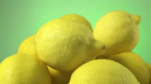 Lemons isolated rotating on green background Stock Footage 62394894
