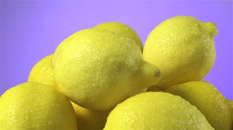 Lemons isolated rotating on purple background Stock Footage 62397234