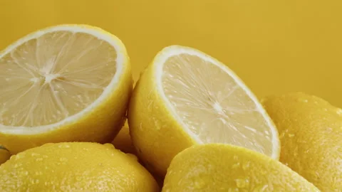 Lemons isolated on yellow background, pouring water on fresh and ripe citrus Stock Footage 170147417