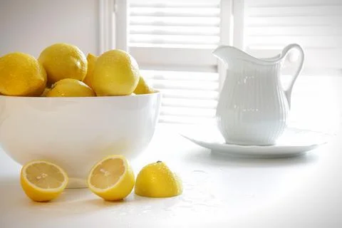 Lemons in large bowl on table Stock Photos