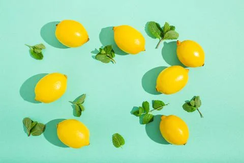 Lemons with mint on minimal blue background sun light hard shadows pattern 스톡 사진
