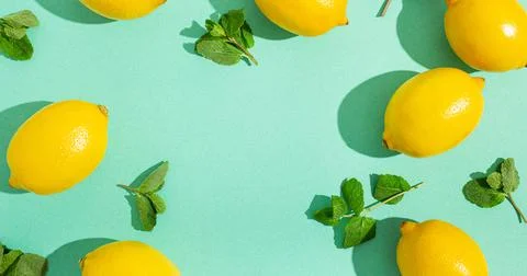 Lemons with mint on minimal blue background sun light hard shadows pattern 스톡 사진