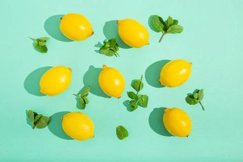Lemons with mint on minimal blue background sun light hard shadows pattern 스톡 사진