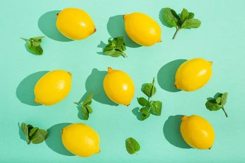 Lemons with mint on minimal blue background sun light hard shadows pattern 스톡 사진