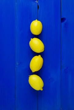Lemons over blue background Stock Photos