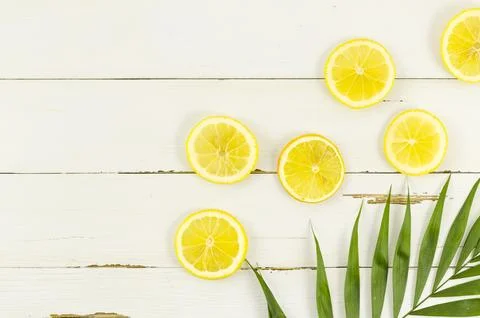 Lemons palm leaf table Stock Photos