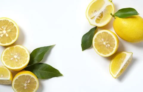 Lemons placed on a white background with copy space and cut in half Stock Photos